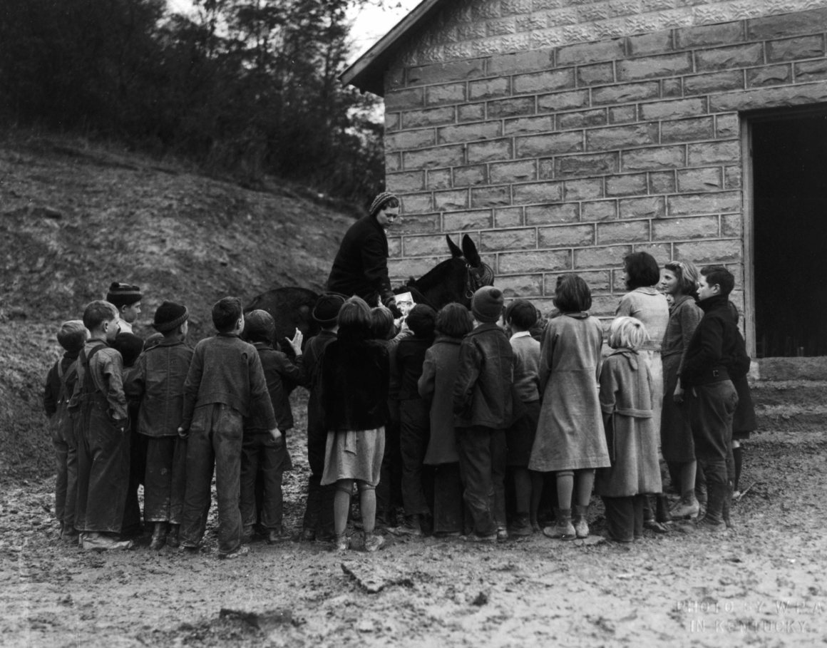 Children surrounded the book women, eager for any reading materials.